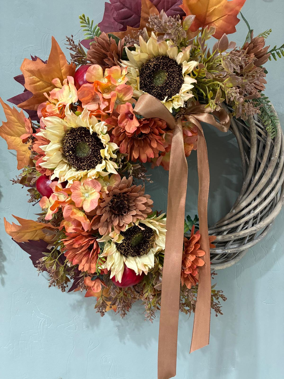 Copper Harvest wreath with sunflowers and a copper ribbon