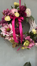 Magnolia and peony wreath with a fuchsia satin ribbon on a white willow ring