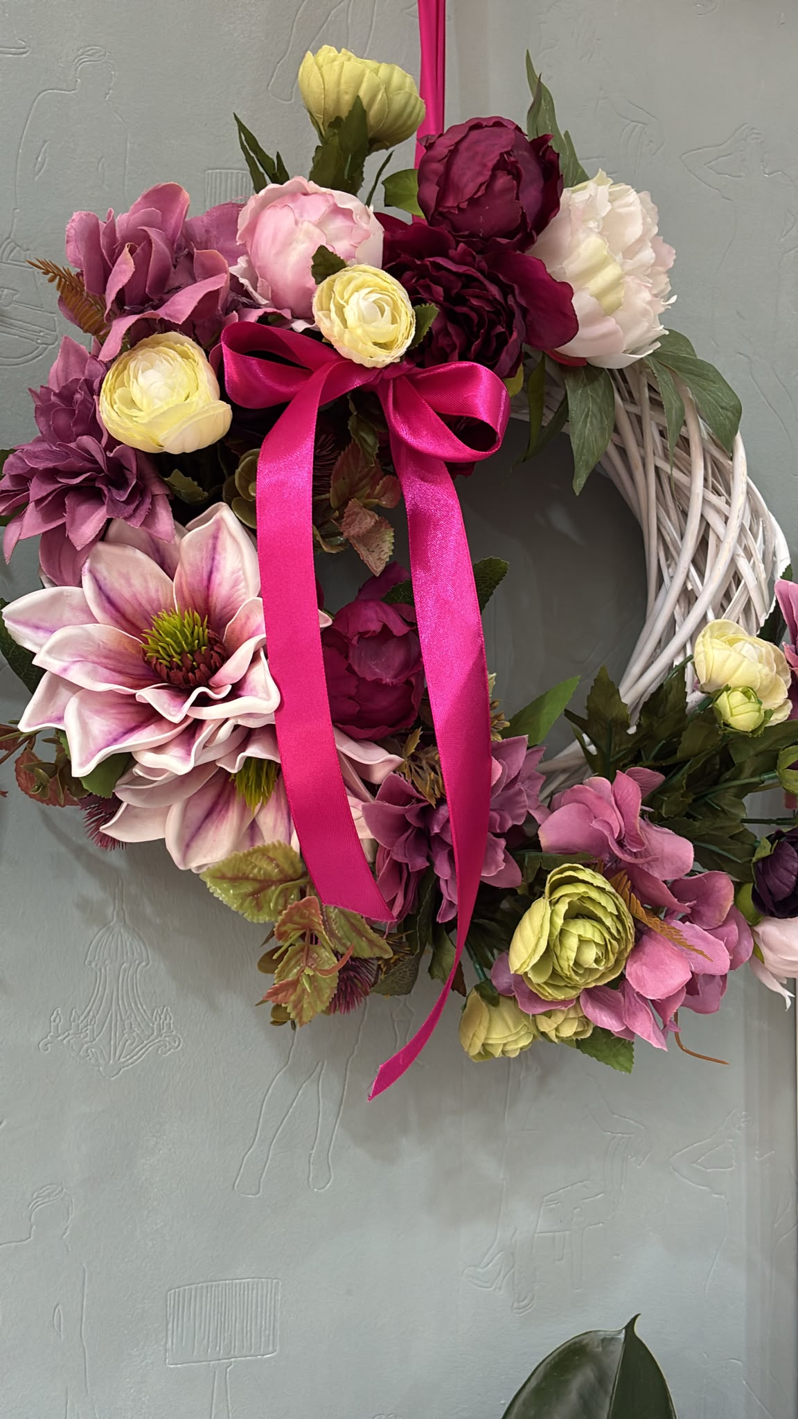 Magnolia and peony wreath with a fuchsia satin ribbon on a white willow ring